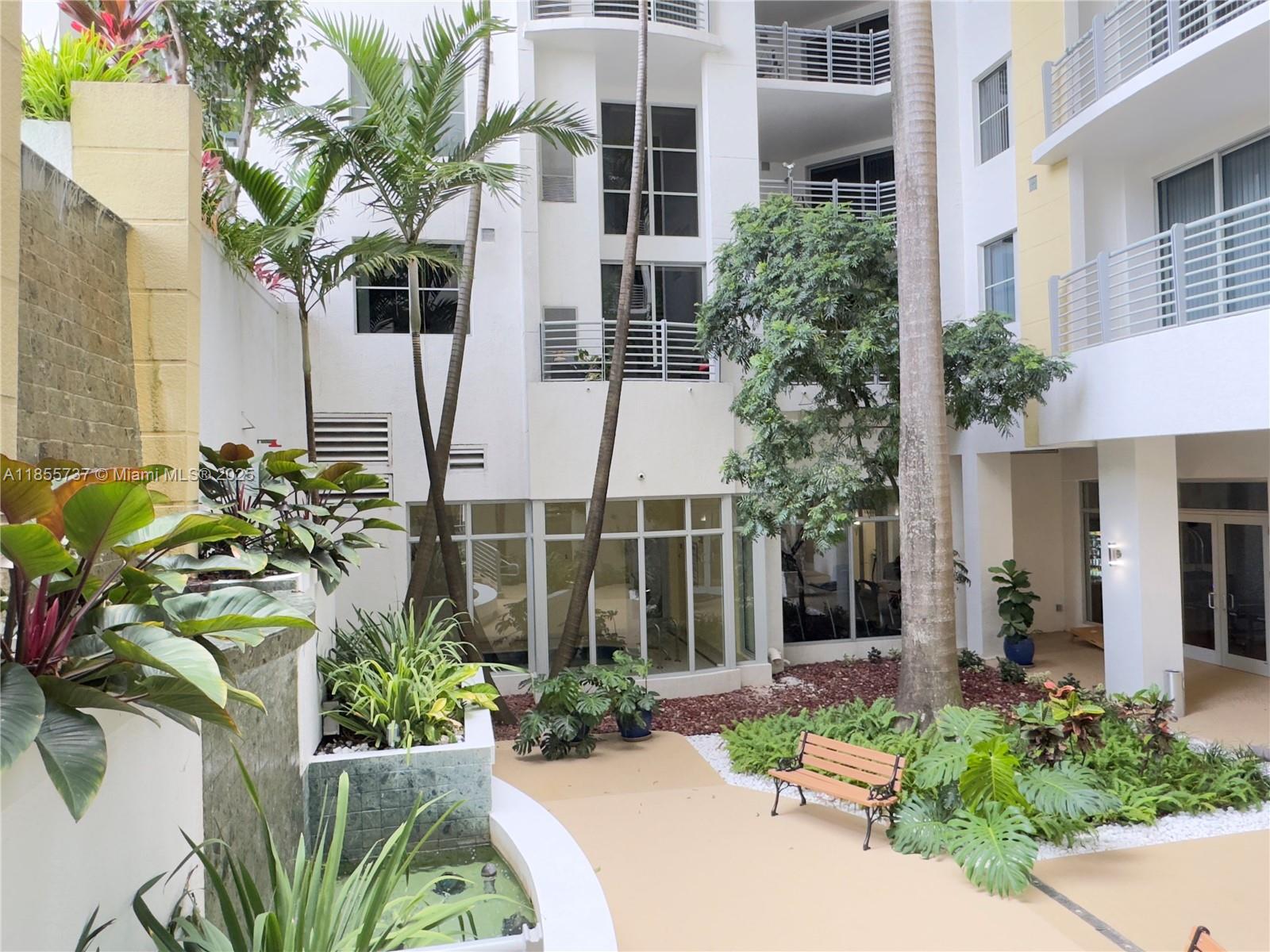 1830 Radius Drive, Unit 1301 Hollywood, FL 33020 - Photo 20 of 41 a view of a building with a garden