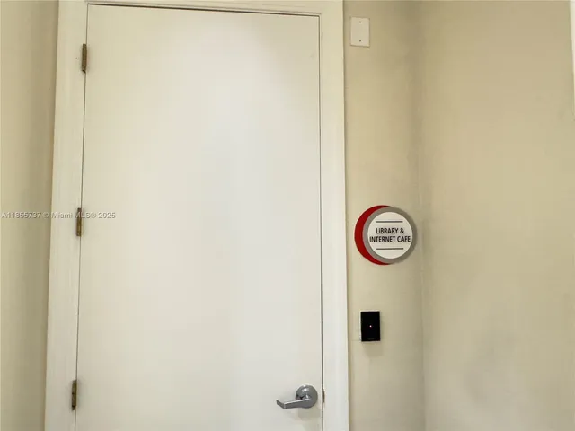 a view of a hallway with a refrigerator and a window
