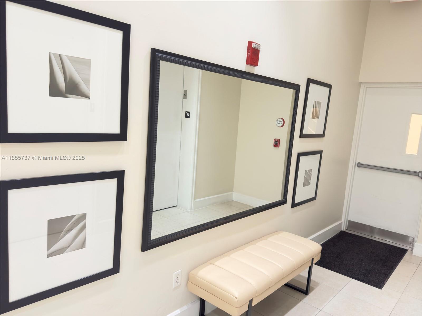 1830 Radius Drive, Unit 1301 Hollywood, FL 33020 - Photo 29 of 41 a living room with furniture and a mirror