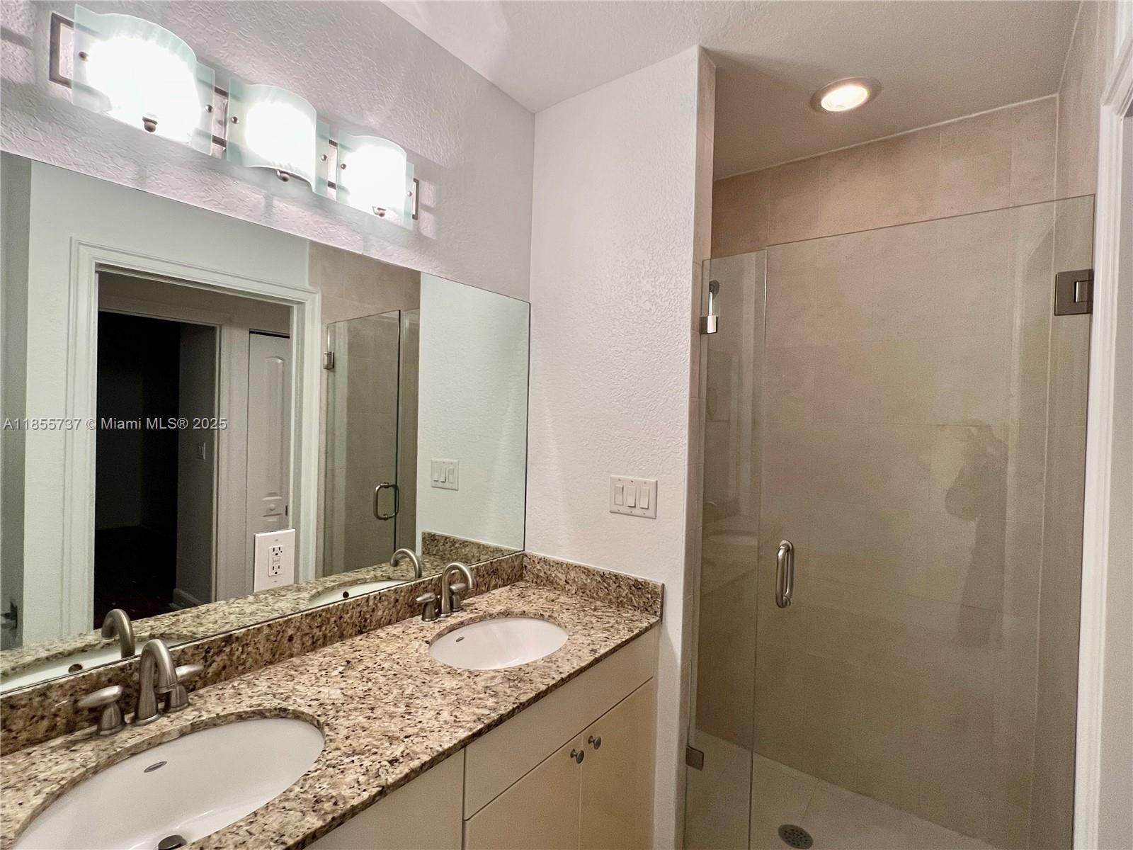 1830 Radius Drive, Unit 1301 Hollywood, FL 33020 - Photo 8 of 41 a bathroom with a granite countertop sink and a mirror