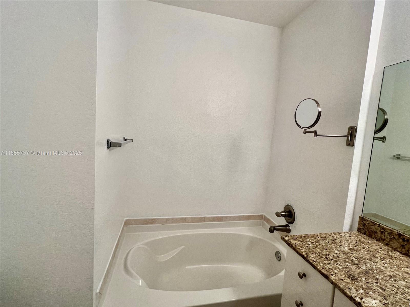 1830 Radius Drive, Unit 1301 Hollywood, FL 33020 - Photo 9 of 41 a bathroom with a granite countertop sink and toilet