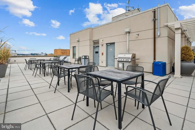 a view of a patio with a table and chairs and potted plants