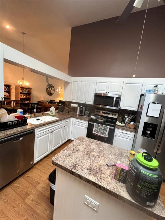 4207 Chesterfield Circle Palm Harbor, FL 34683 - Photo 2 of 7 a kitchen with sink refrigerator and stove