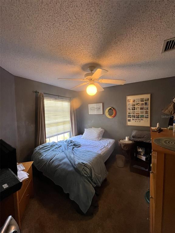 4207 Chesterfield Circle Palm Harbor, FL 34683 - Photo 6 of 7 a bedroom with a bed and a tv