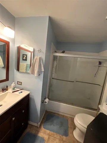 a bathroom with a sink a toilet and mirror