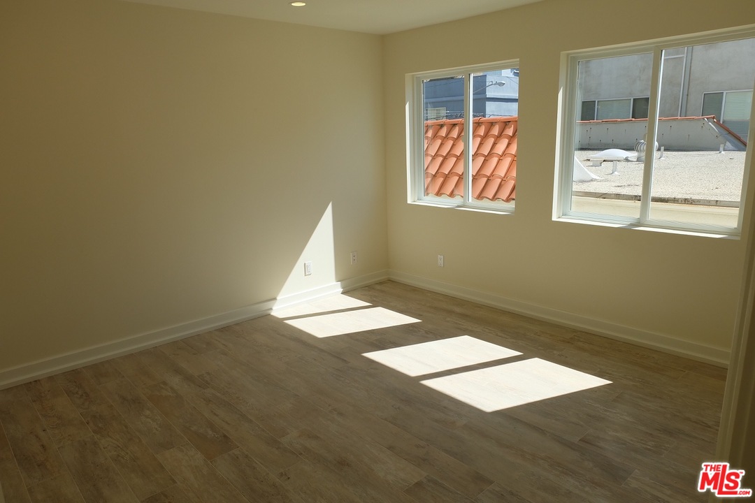 2 Catamaran Street, Unit 2 Marina del Rey, CA 90292 - Photo 13 of 17 an empty room with wooden floor and windows
