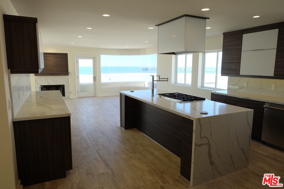 2 Catamaran Street, Unit 2 Marina del Rey, CA 90292 - Photo 3 of 17 a kitchen with stainless steel appliances granite countertop a sink a stove and a refrigerator