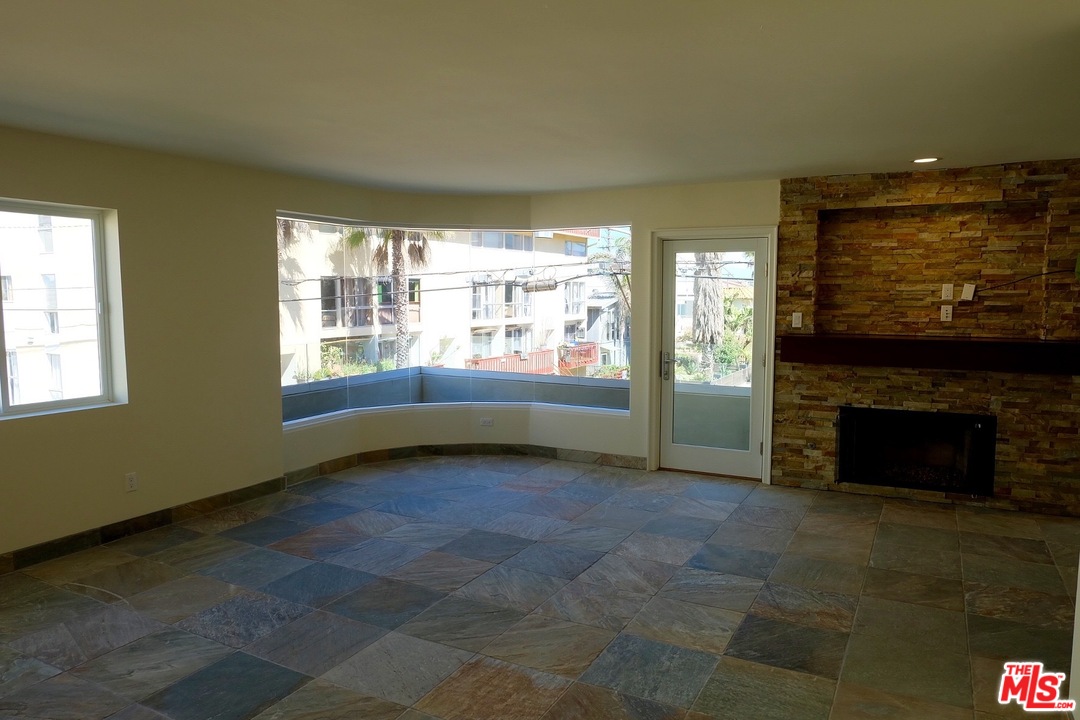 2 Catamaran Street, Unit 2 Marina del Rey, CA 90292 - Photo 6 of 17 a view of an empty room with a fireplace and a window
