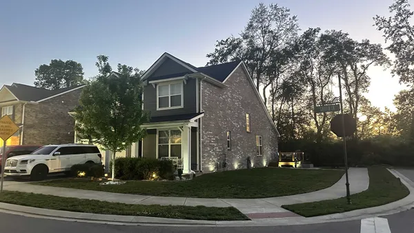 a front view of a house with a yard