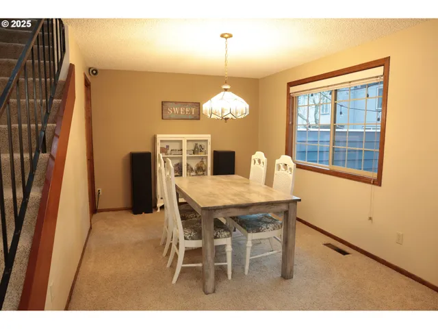 a dining room with furniture and window