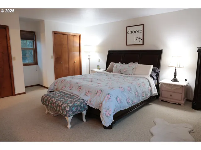 a bedroom with a bed and a night stand