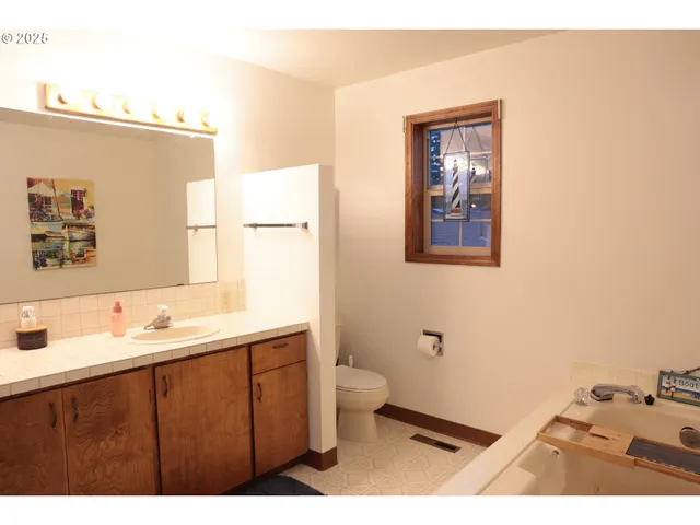a bathroom with a sink mirror and toilet