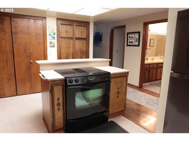 a kitchen with a stove a sink and a refrigerator