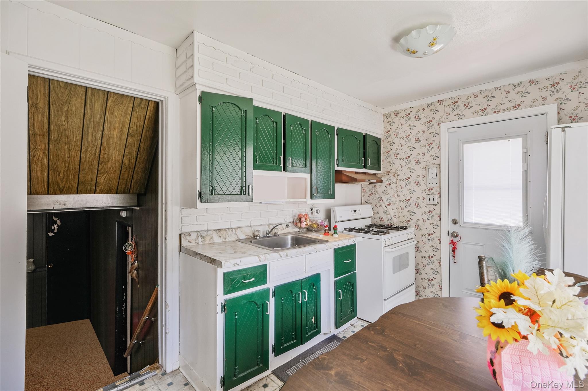 59 Maybrook Road North Babylon, NY 11703 - Photo 11 of 43 a kitchen with a stove a sink and a refrigerator