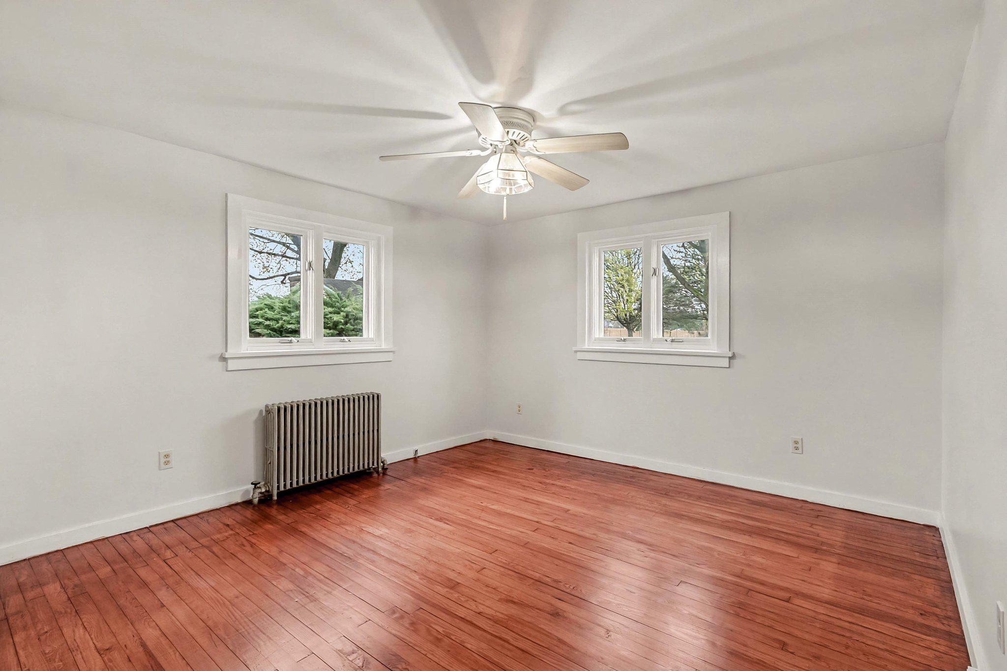 201 4th Street Boiling Springs, PA 17007 - Photo 14 of 34 a view of an empty room with wooden floor and a window
