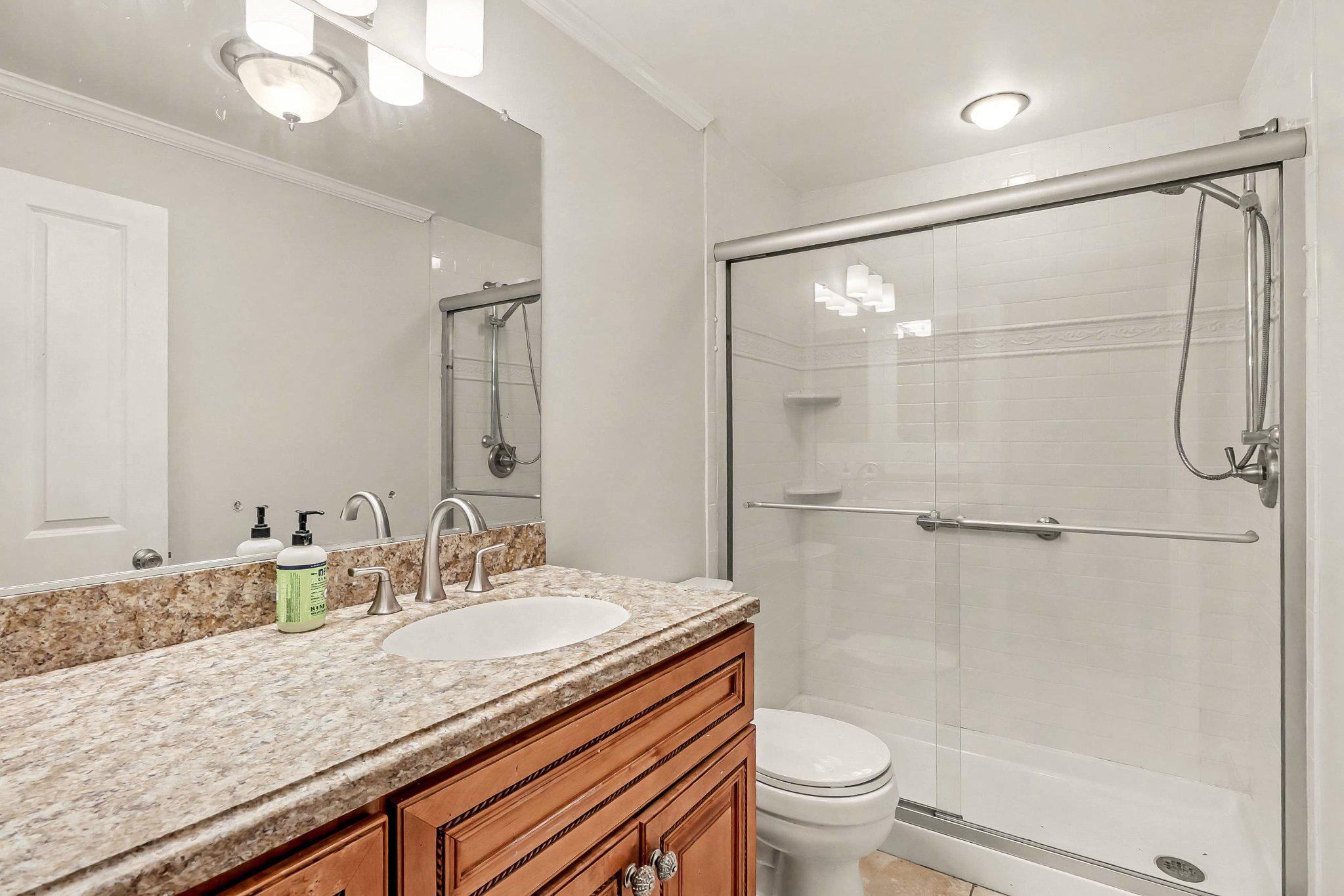 201 4th Street Boiling Springs, PA 17007 - Photo 16 of 34 a bathroom with a granite countertop sink toilet and shower