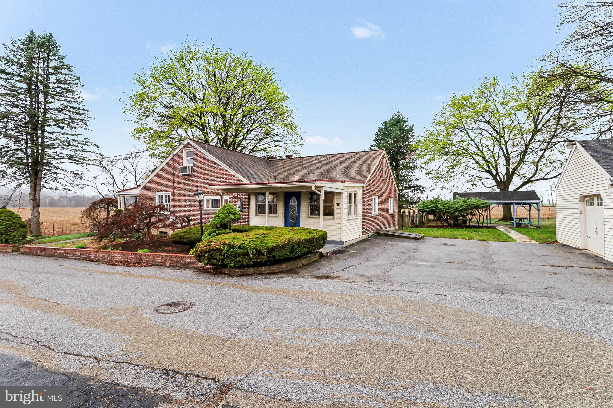 201 4th Street Boiling Springs, PA 17007 - Photo 2 of 34 a front view of a house with a yard and garage