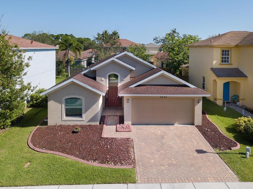 a front view of a house with a yard and garage