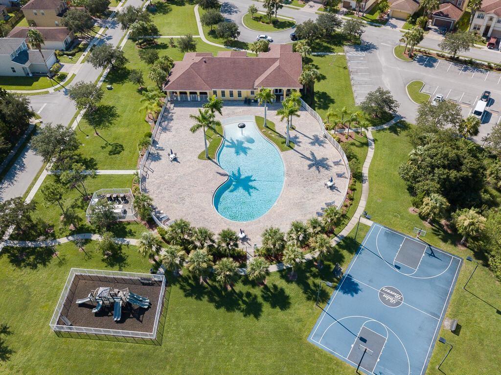 9446 Windrift Circle Fort Pierce, FL 34945 - Photo 13 of 13 an aerial view of a house with a garden and swimming pool