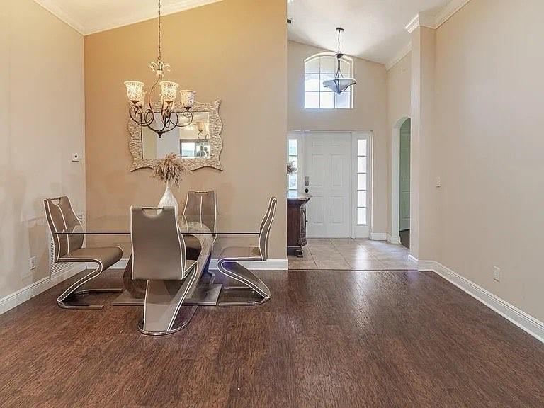 9446 Windrift Circle Fort Pierce, FL 34945 - Photo 4 of 13 a view of a dining room with furniture a chandelier and wooden floor