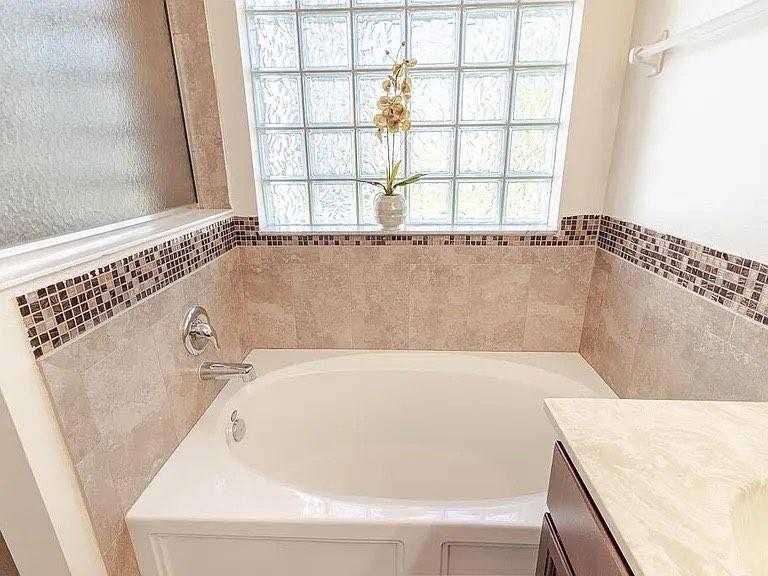 9446 Windrift Circle Fort Pierce, FL 34945 - Photo 10 of 13 a bathroom with a bathtub