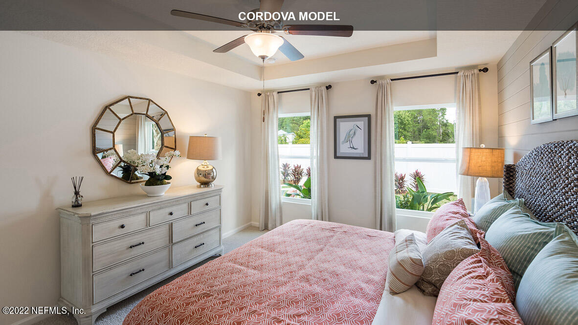 65680 Edgewater Drive Yulee, FL 32097 - Photo 14 of 48 a bedroom with a bed and a dresser