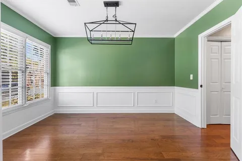 a view of room with window and wooden floor