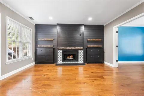 a view of an empty room with a fireplace and a window