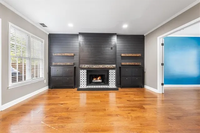 a view of an empty room with a fireplace and a window