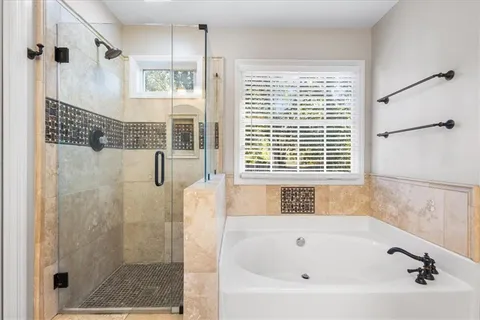 a bathroom with a bathtub and a shower