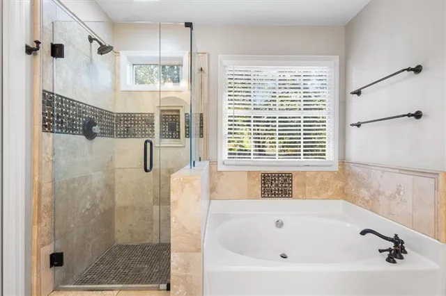 a bathroom with a bathtub and a shower