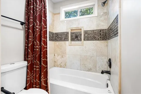 a bathroom with a bathtub and shower