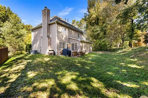 a view of a house with a backyard