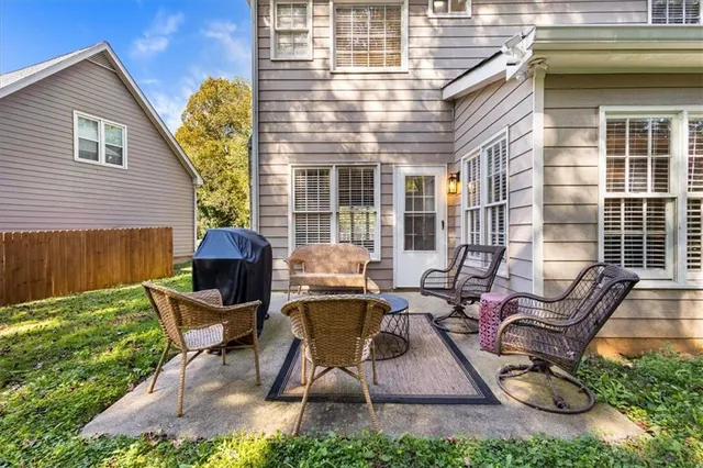 a view of a patio with table and chairs with wooden floor and fence