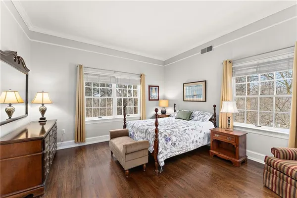 a bedroom with a bed and a couch with window