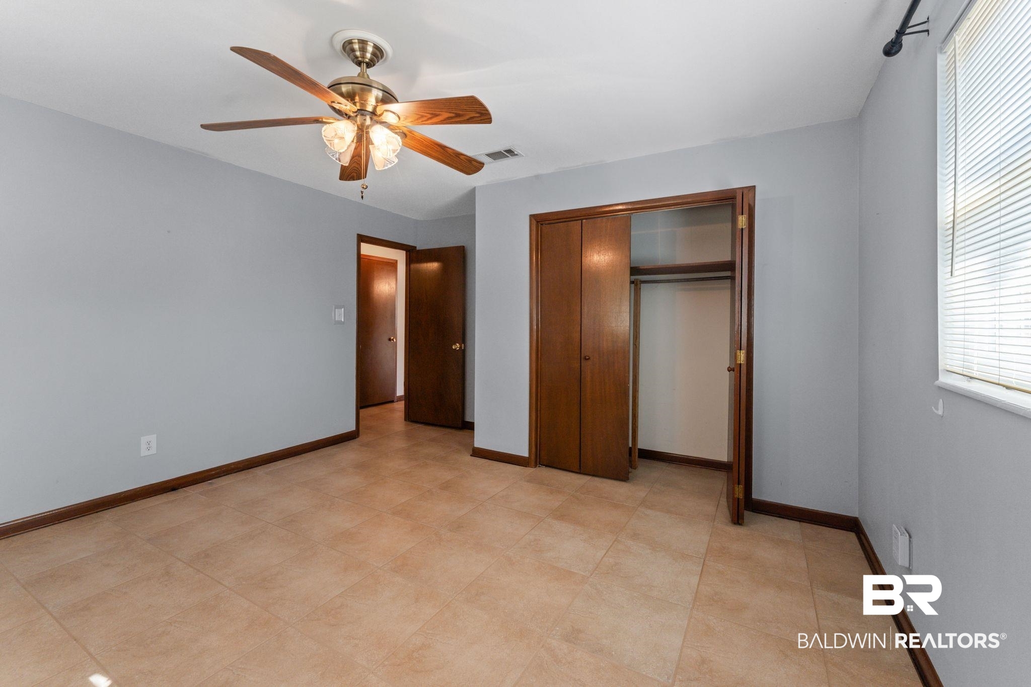 32989 Antietam Road Lillian, AL 36549 - Photo 16 of 56 Unfurnished bedroom with ceiling fan and a closet