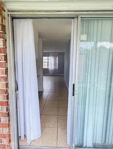 a view of empty room with window and chandelier