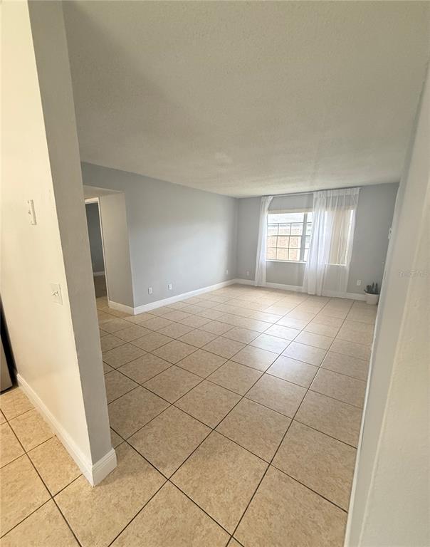 5325 Curry Ford Road, Unit G202 Orlando, FL 32812 - Photo 13 of 16 a view of empty room with window and chandelier