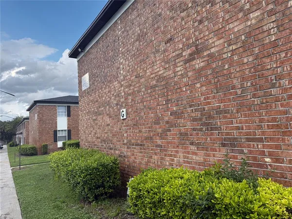 a brick building with a yard