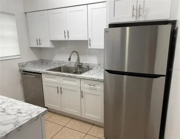 a kitchen with a sink and a refrigerator