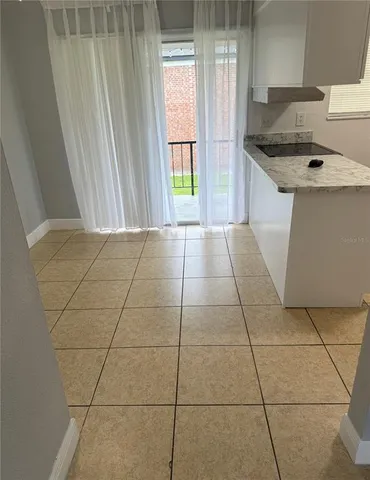a kitchen with a sink a stove and cabinets