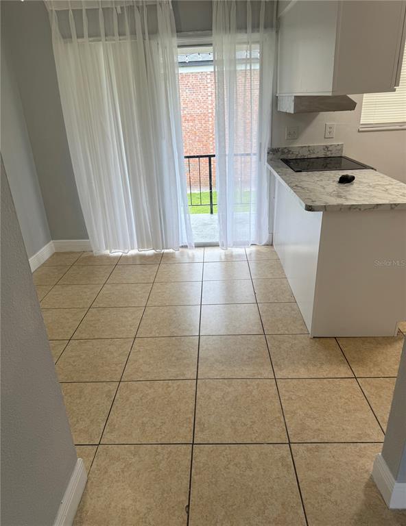 5325 Curry Ford Road, Unit G202 Orlando, FL 32812 - Photo 9 of 16 a kitchen with a sink a stove and cabinets