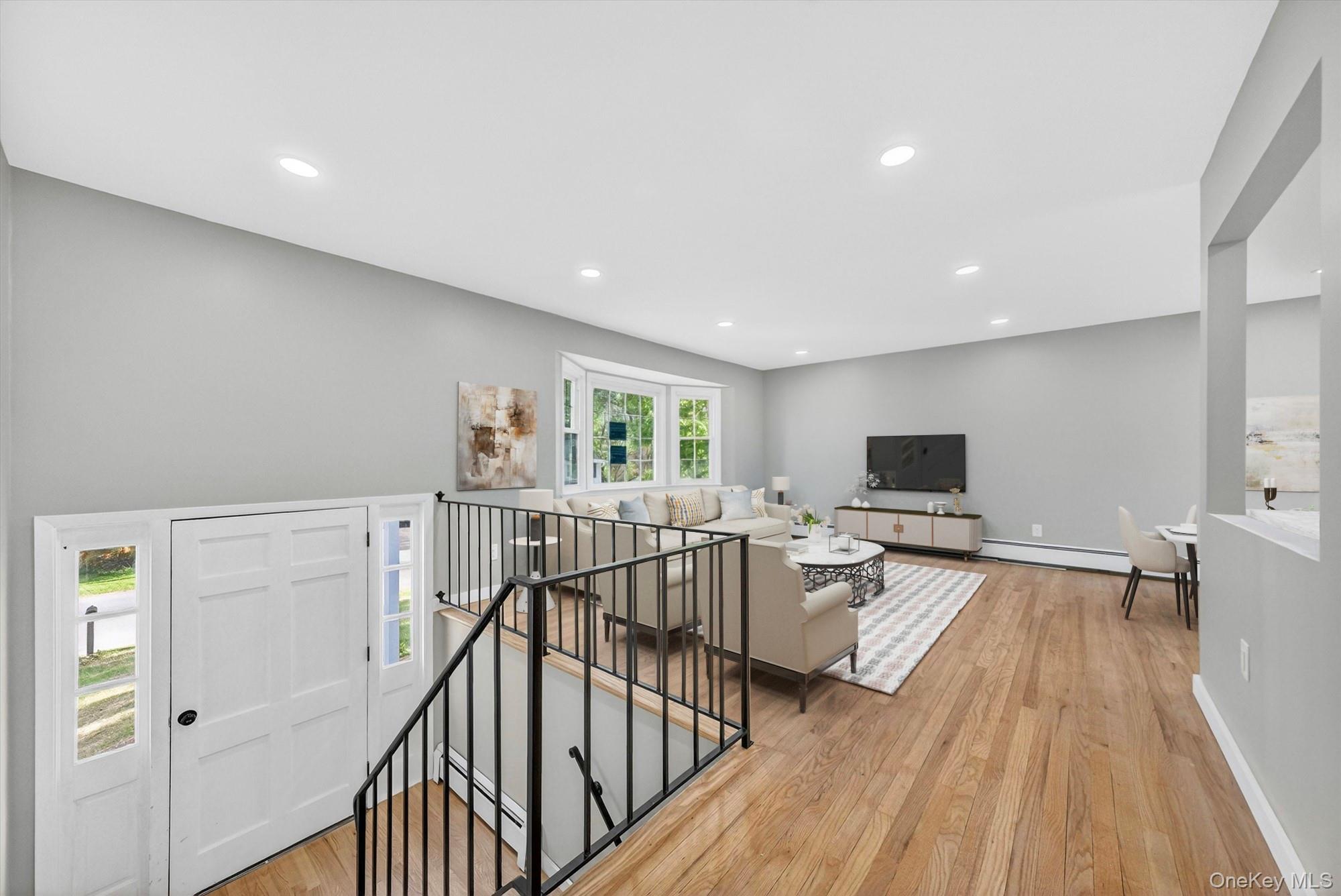 8 Mockingbird Lane Poughkeepsie, NY 12601 - Photo 2 of 32 Virtually Staged. A bright and welcoming living room with plenty of natural light, offering a comfortable space to relax, gather, and enjoy everyday living.