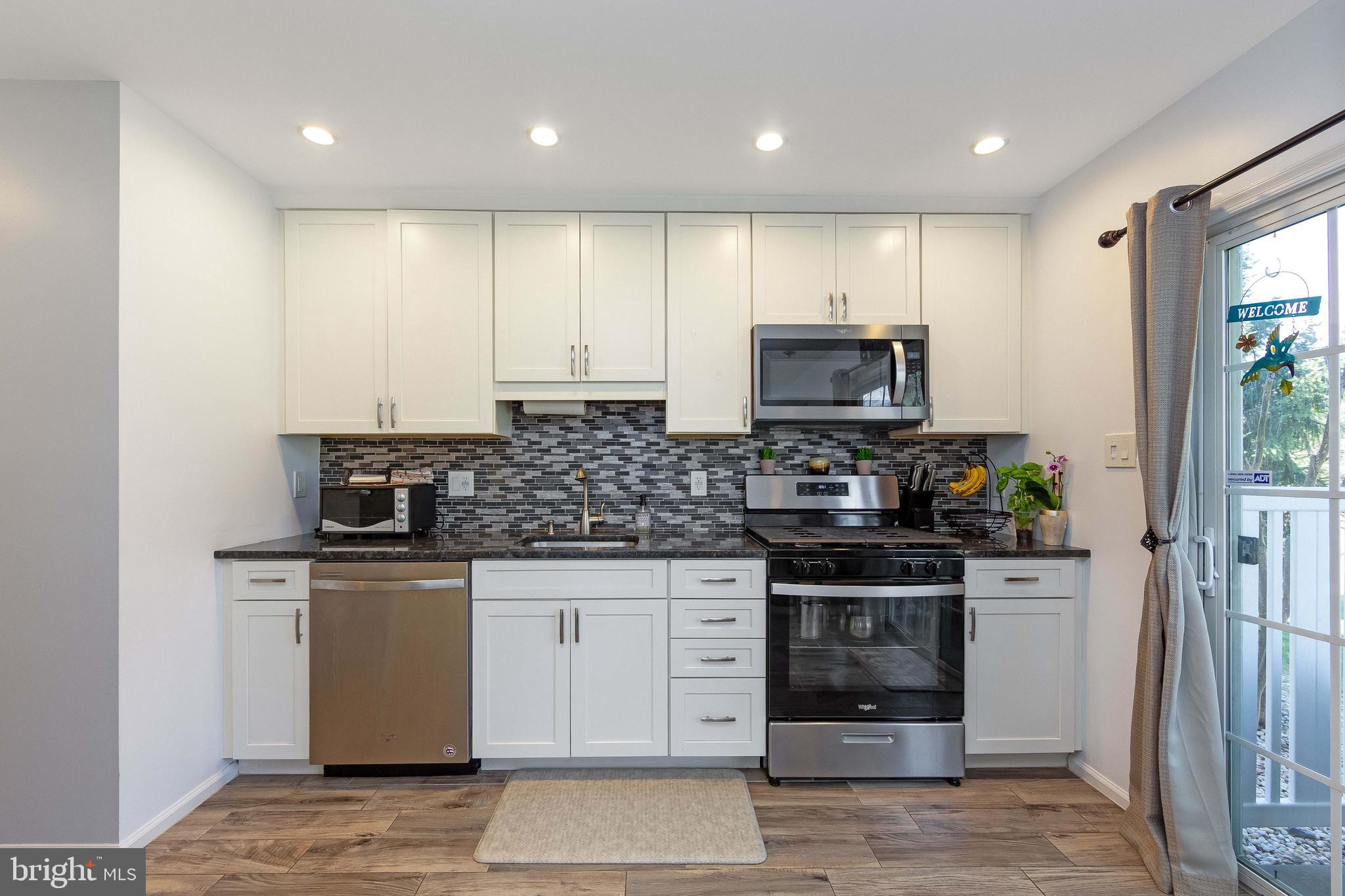 803 Tanglewood Drive Sicklerville, NJ 08081 - Photo 11 of 34 a kitchen with stainless steel appliances granite countertop a stove a sink and a microwave