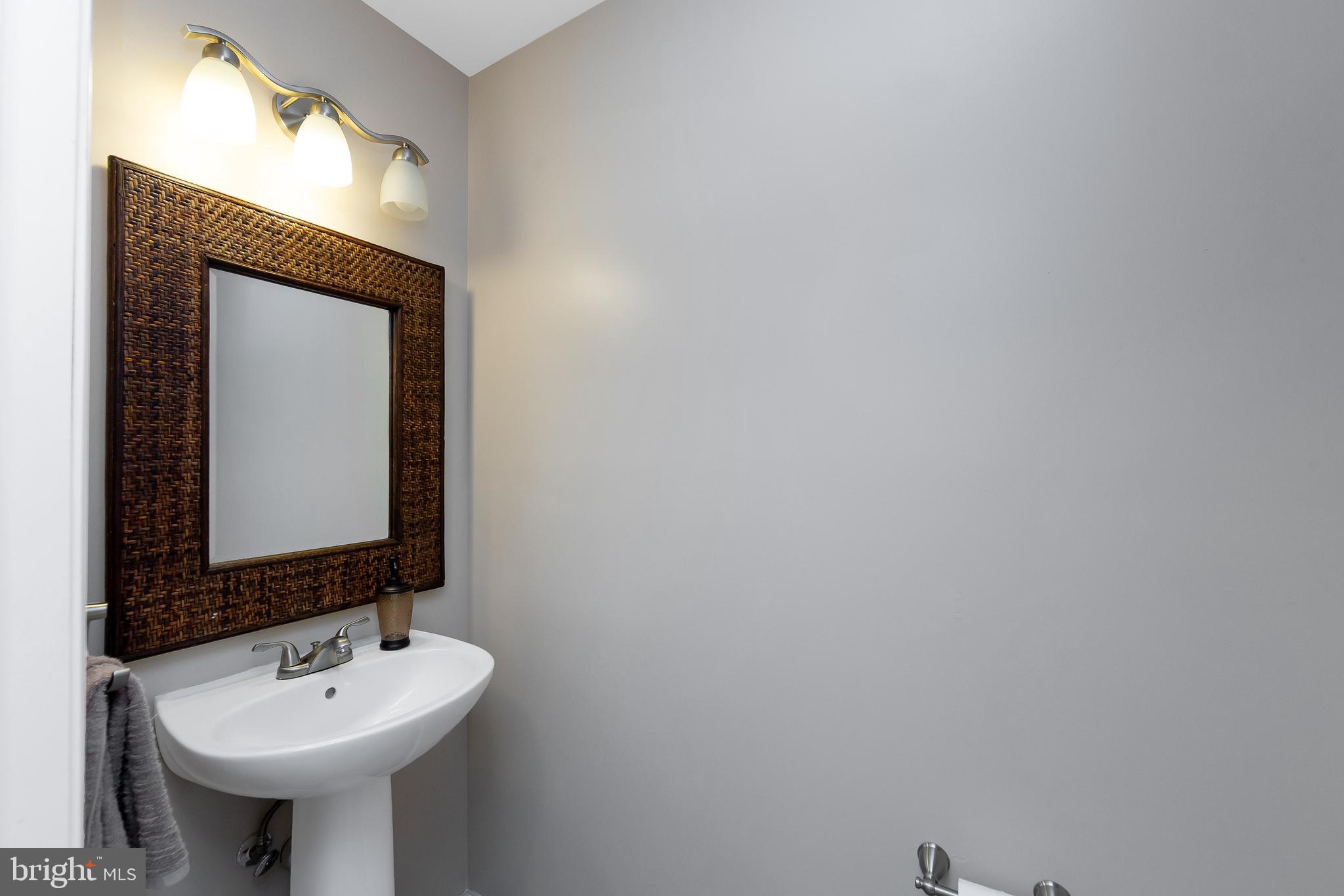 803 Tanglewood Drive Sicklerville, NJ 08081 - Photo 14 of 34 a bathroom with a sink and a mirror