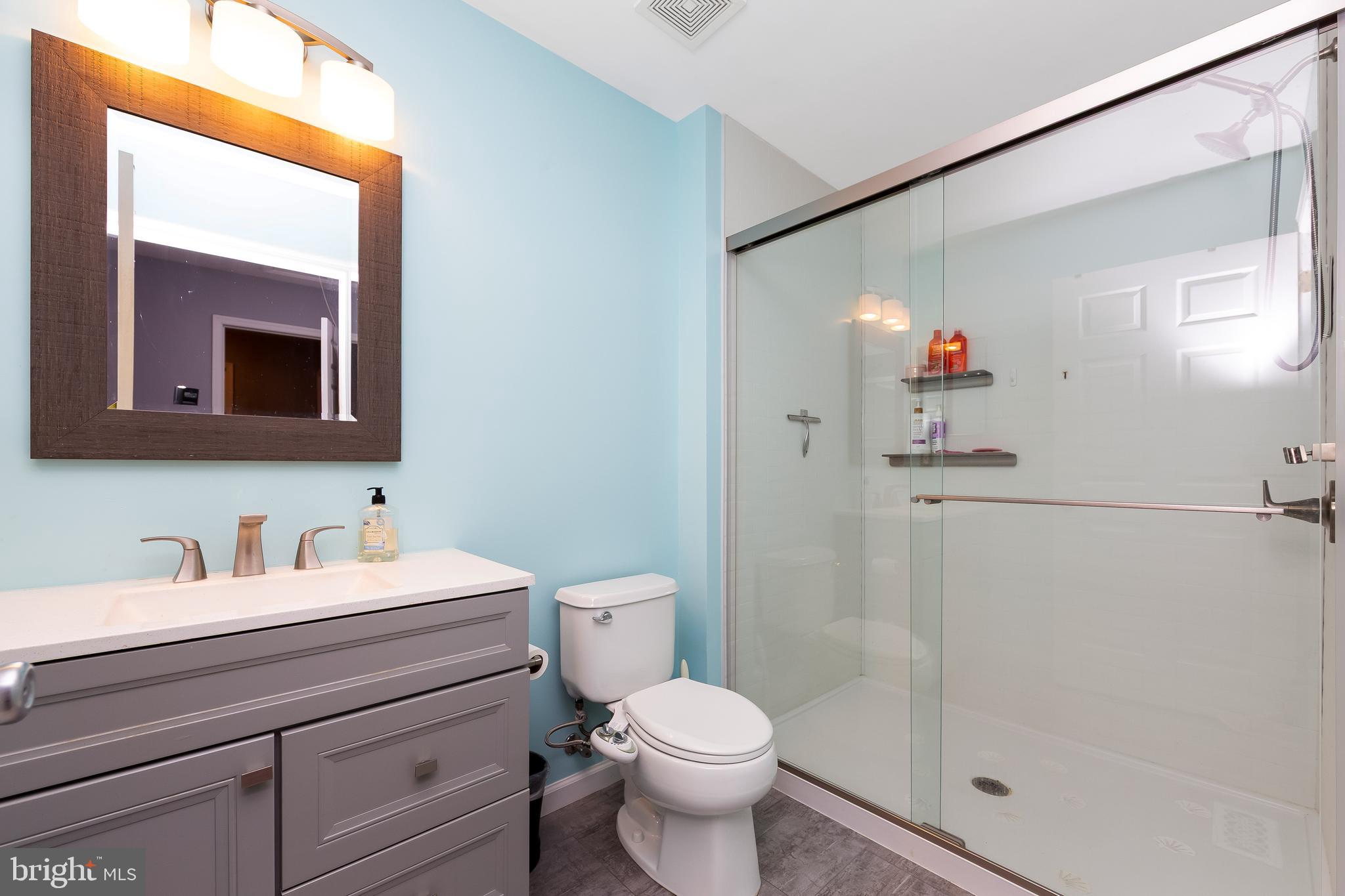 803 Tanglewood Drive Sicklerville, NJ 08081 - Photo 21 of 34 a bathroom with a toilet sink and mirror