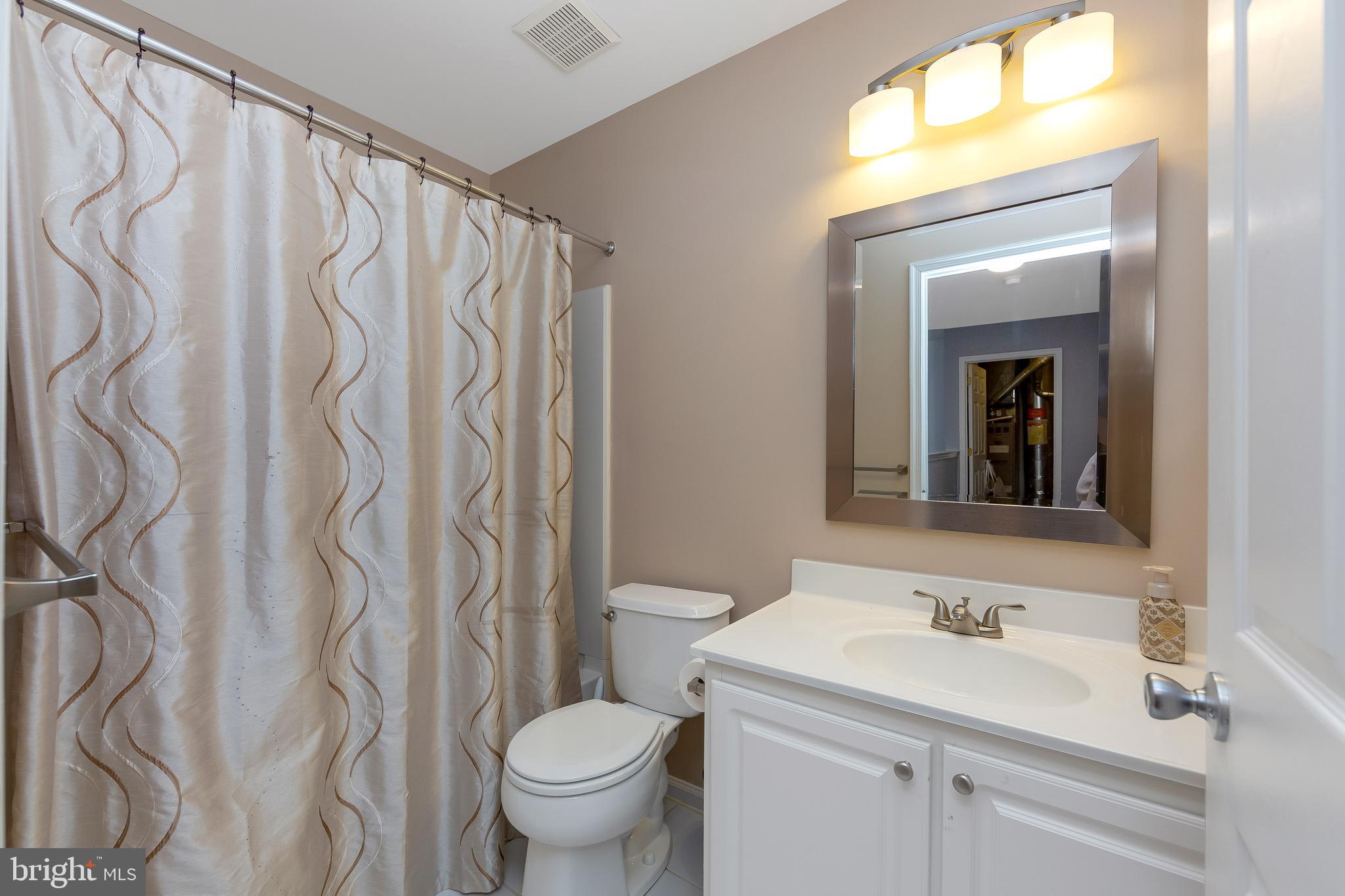 803 Tanglewood Drive Sicklerville, NJ 08081 - Photo 26 of 34 a bathroom with a sink a toilet and a mirror