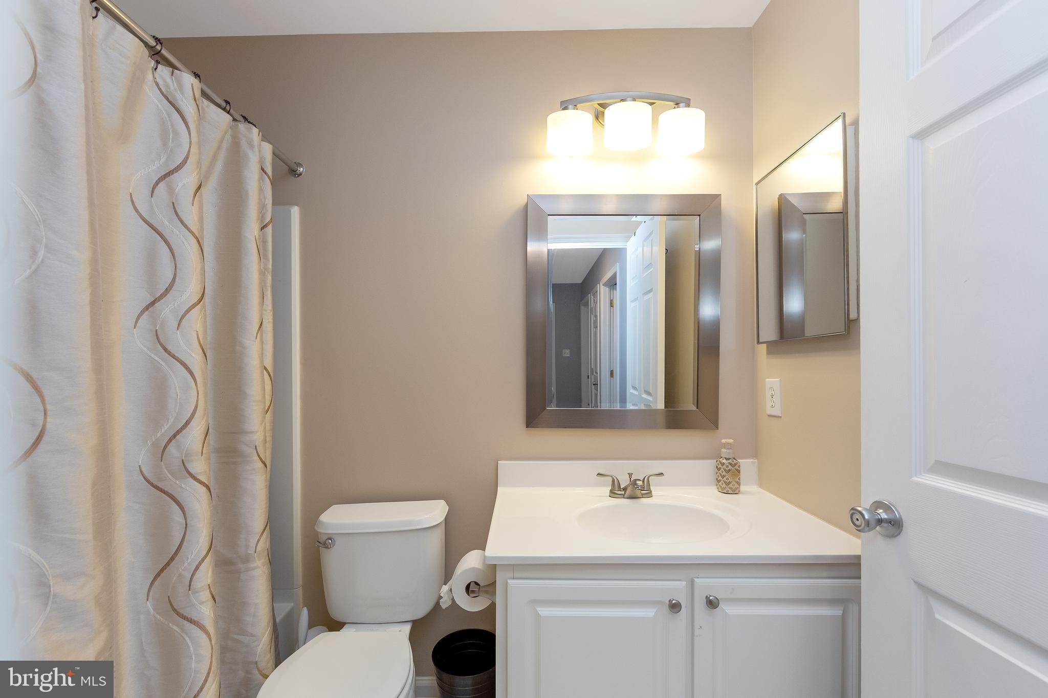 803 Tanglewood Drive Sicklerville, NJ 08081 - Photo 27 of 34 a bathroom with a sink a toilet and a mirror