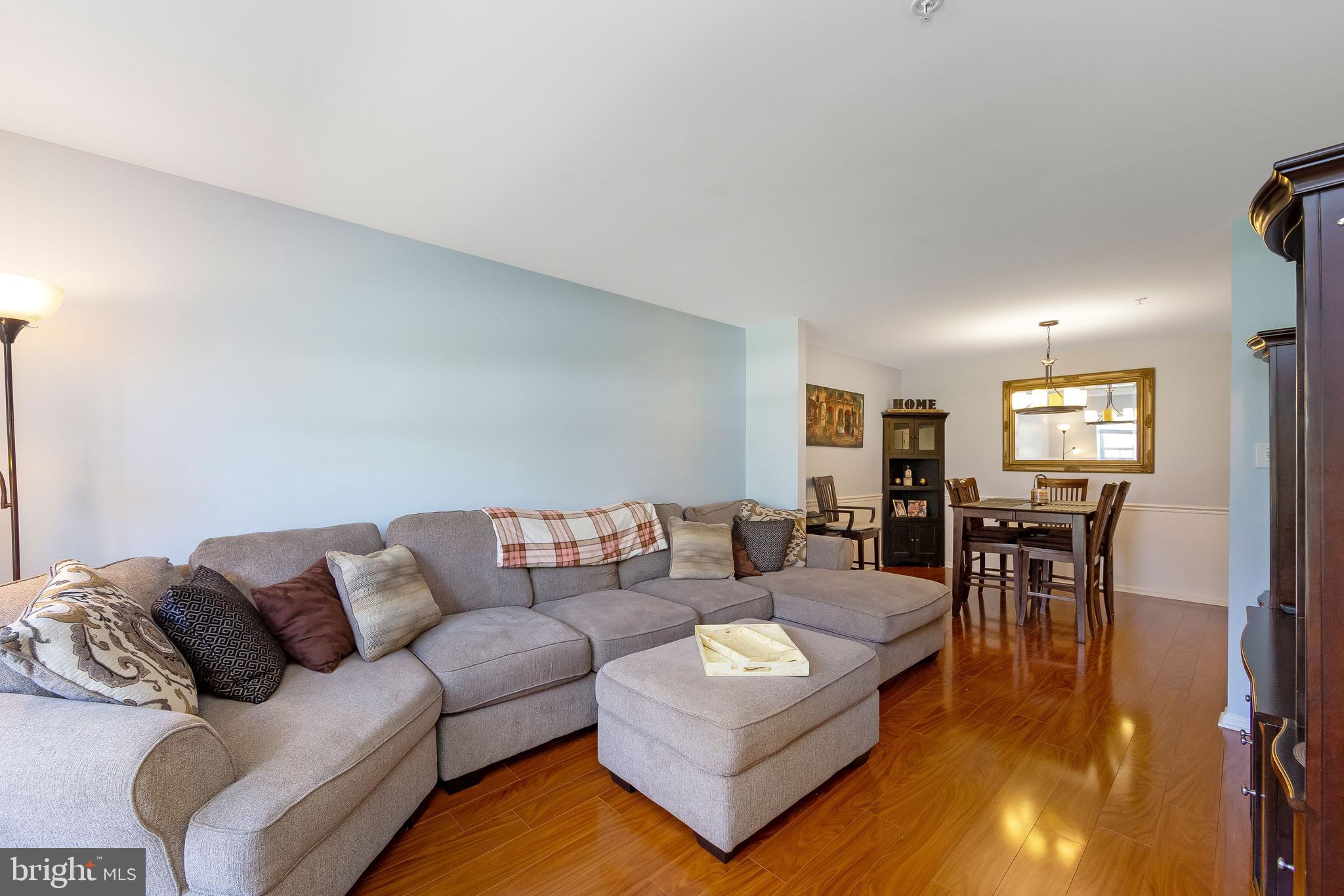 803 Tanglewood Drive Sicklerville, NJ 08081 - Photo 7 of 34 a living room with furniture and a dining table with wooden floor
