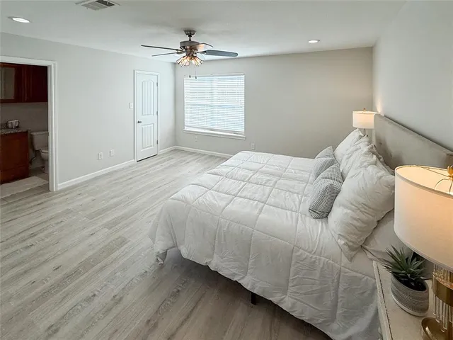 a bed room with a bed and a television